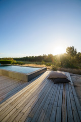 Modern house with garden swimming pool and wooden deck