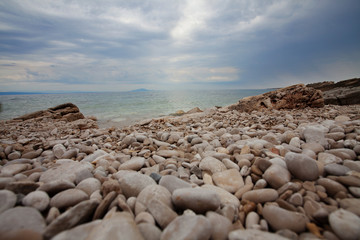 Rocky beach at sunset. Stones close up