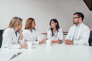 Hospital staff meeting in conference room.