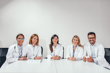 Fototapeta premium Successful team of medical doctors are looking at camera. Copy space.