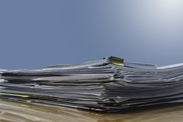 stack of documents on desktop in office.