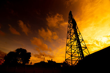 Derrick Pile At sunset, silhouette