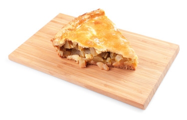Wooden board with piece of apple pie on white background