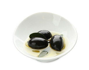 Bowl with oil and canned olives on white background