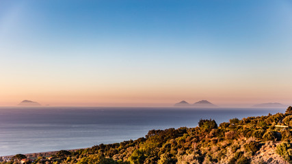 View of Aeolian islands from the sicilian coast at sunset