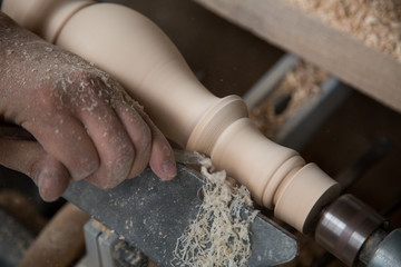Carpenter turning hard wood on a lathe  hands close up