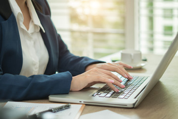 Woman working at home office hand on keyboard close up