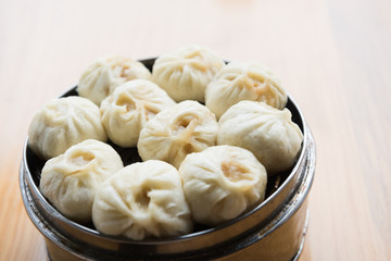 Xiaolongbao, dim sum in bamboo steamer. Dumplings in bamboo steamer
