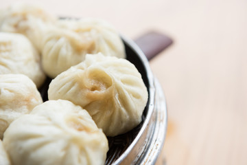 Asian Cuisine. Steamed dumplings in a bamboo steamer. 