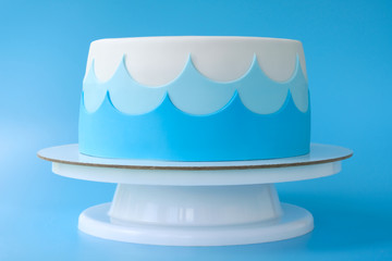Сake for the child's birthday, decorated with sea waves on a blue background. Picture for a menu...