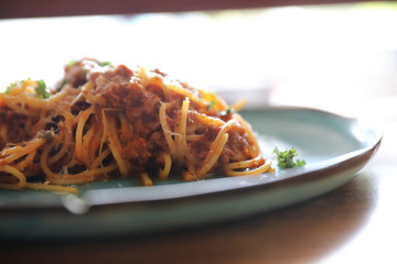 spaghetti Bolognese with minced beef and tomato sauce garnished with parmesan cheese and basil , Italian food