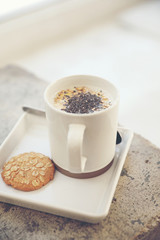 Cereal on milk in cup with woman hand breakfast
