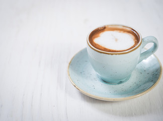 Milky morning coffee over rustic white wood and copy space