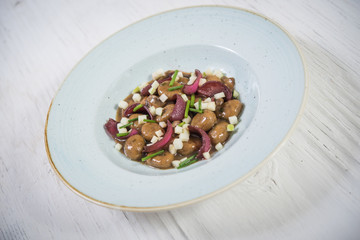 Cooked potato with red onion in plate