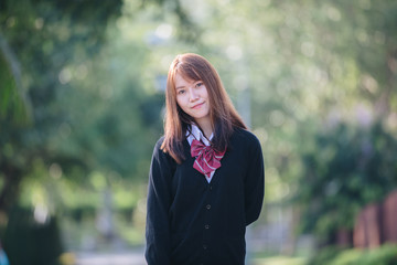 Portrait of asian japanese school girl costume looking at park outdoor film vintage style