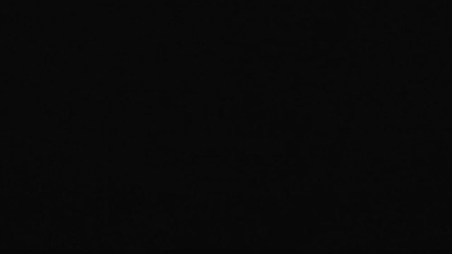 Nightmare shot of a demon face in the darkness moving around screaming and being scary while a light flashes on his face to add drama to the scene