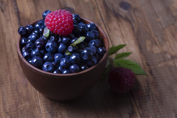 full bowl of ripe blueberry on a dark background