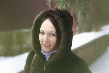 Girl in a fur coat in winter, softfocus, toned