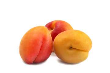 Fototapeta na wymiar three sweet fruits of ripe juicy colorful apricots
