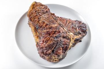 White round plate with Whole grilled T-bone steak