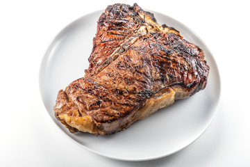 White round plate with Whole grilled T-bone steak