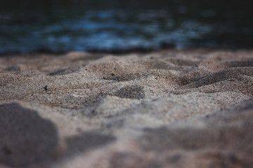 Golden sand dunes and the sea. The effect of the macro on the beach