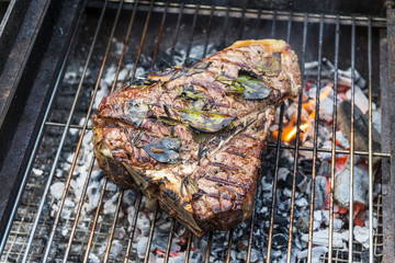 Whole T-Bone steak cooking on grill