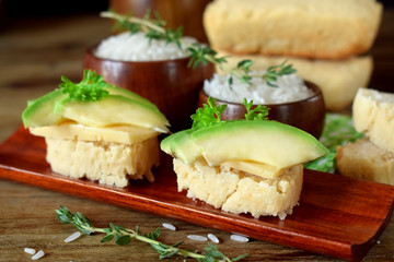 Fototapeta na wymiar Sandwiches with cheese and avocado slices on pieces of rice gluten free bread
