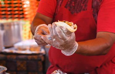 Man Serving a Gyro at a Local Festival
