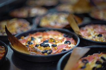 Preparation Mini pizza for children, on an iron table
