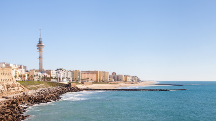 Fototapeta na wymiar Playa Santa Maria del Mar. A view of the Cadiz waterfront in Spain and the view along Playa Santa Maria del Mar.
