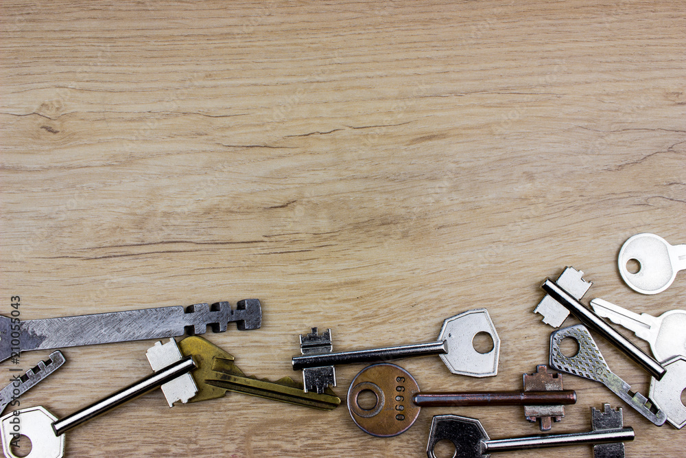 Poster different vintage keys on a table. empty space for your text and design.