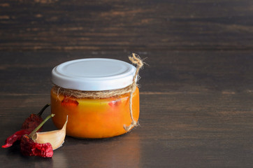 Glass jar of Typical Canary Islands sauce, mojo picon, made from of small red peppers and it is are popular souvenir of the fun holiday experience. Copy space