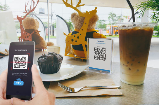 Qr code payment, E wallet , cashless technology concept. Man scanning tag in Coffee shop accepted generate digital pay without money.