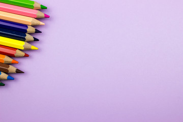 Pencils set on a color paper. Empty space for text and design. Minimalism concept