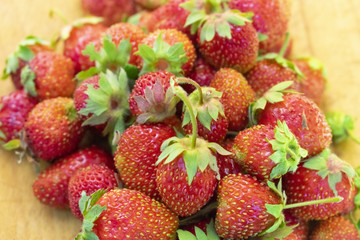 collected red ripe strawberry, on a wooden board, close-up