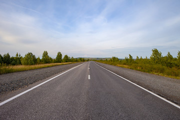 An empty road leading to the village on the hills.