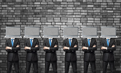 Businessmen with laptops instead of head.