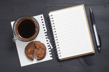 Obraz na płótnie Canvas Notebook and coffee with cookie
