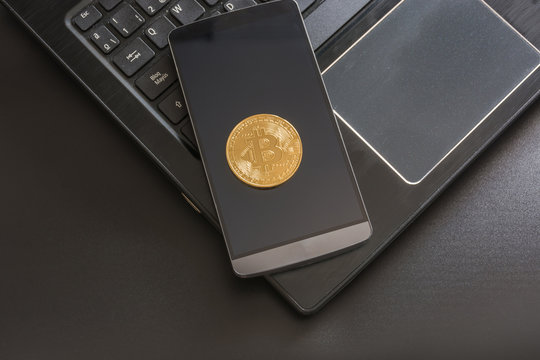 cryptocurrency called bitcoin with laptop and a smartphone.