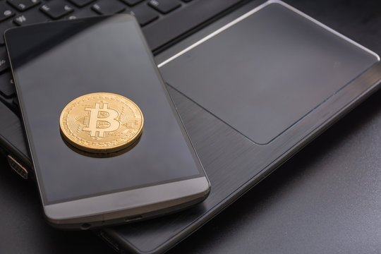 cryptocurrency called bitcoin with laptop and a smartphone.