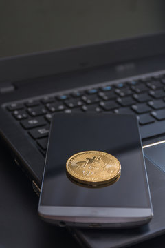 cryptocurrency called bitcoin with laptop and a smartphone.