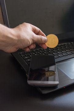 cryptocurrency called bitcoin with laptop and a smartphone.
