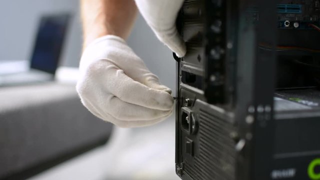 Tightening screw on PC personal computer case by technician meintenance stuff