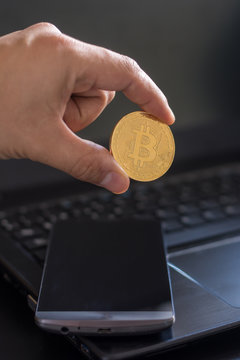 cryptocurrency called bitcoin with laptop and a smartphone.
