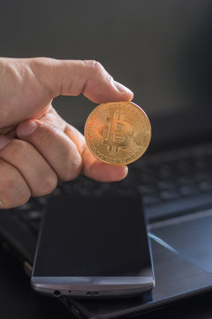 cryptocurrency called bitcoin with laptop and a smartphone.