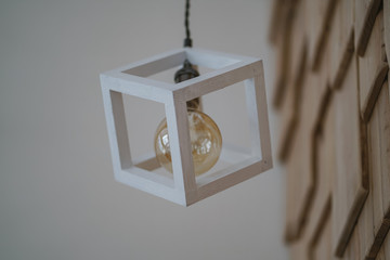 Decorative wooden lamp in the form of a cube