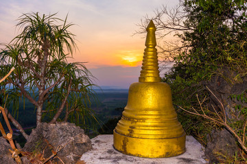  sunrise behind the golden stupa on high mountain .