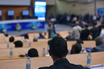Businesspeople during business conference in conference room or hall
