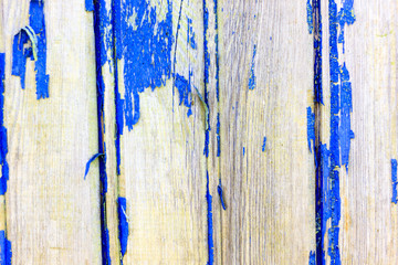 Ancient wooden background with paint. The paint from the sun almost peeled off. Shallow depth of cut